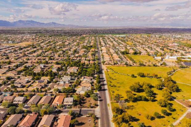 Stunning aerial view of a suburban neighborhood in Arizona with clear skies.